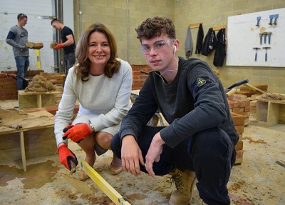 Gillian Keegan MP learning about bricklaying at Chichester College. She is the Chair of the All-Party Parliamentary Group for Apprentices and was an apprentice at 16 in Liverpool